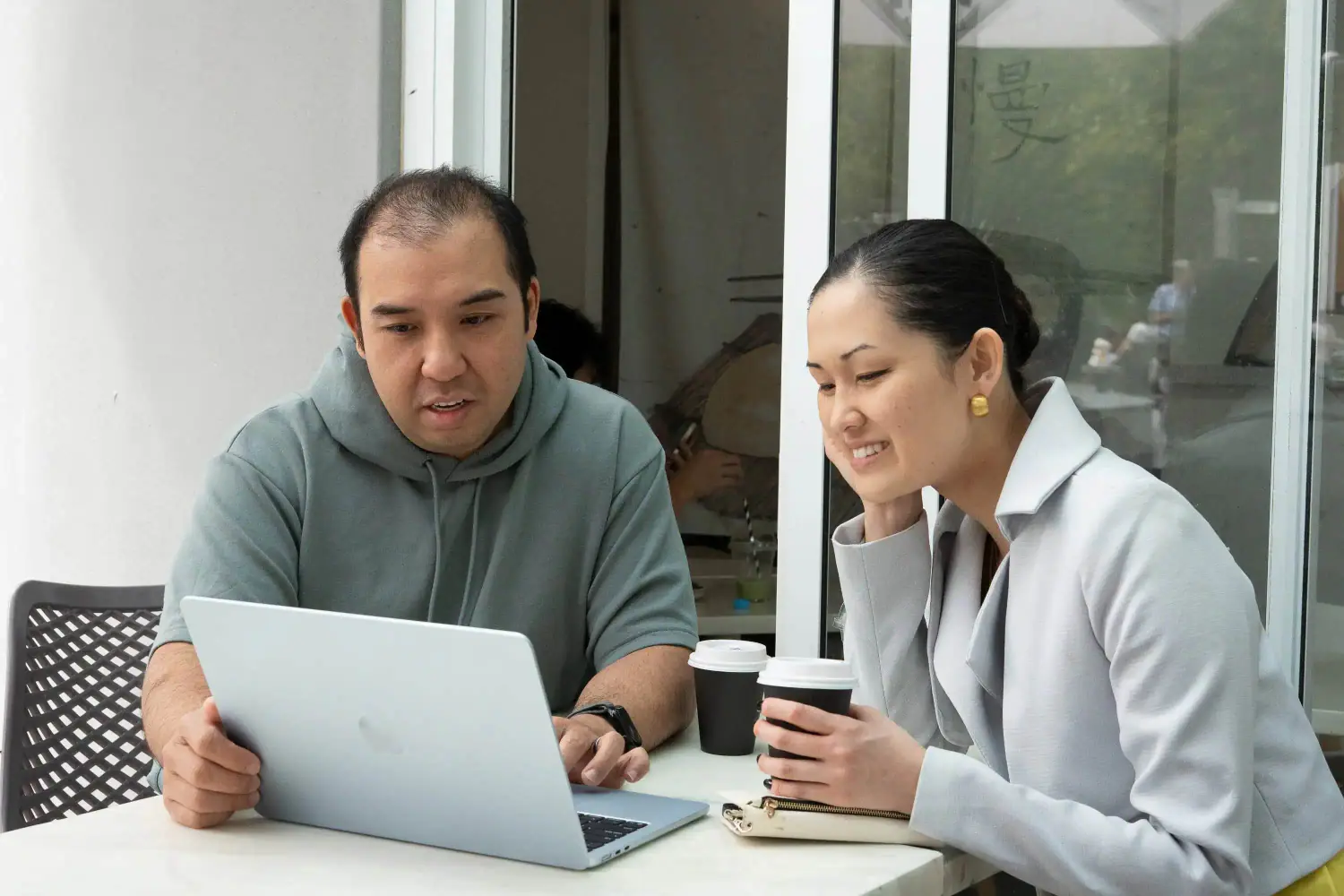 David from Seedwell Co. reviewing a small business's website with the owner over coffee